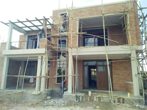 Façade de villa en brique réalisée par PACOR Constructions
